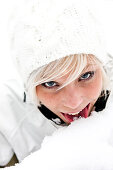 Young woman tasting snow