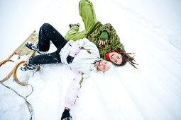 Two laughing young women in snow