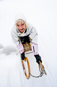 Young woman tobogganing