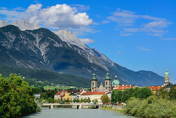 View over Inn river to Cathedral of St. James and City Tower, Karwendel with mount Bettelwurf in background, Innsbruck, Tyrol, Austria