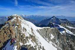 Several persons climbing on ridge to Gran Paradiso, Mont Blanc in background, Gran Paradiso, Gran Paradiso Nationalpark, Graian Alps range, valley of Aosta, Aosta, Italy