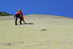 Man climbing on granite slab, Sector Crow, Grimsel pass, Bernese Oberland, Switzerland