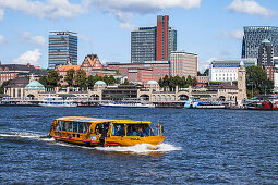 Excursion boat on Elbe river, St. Pauli Landing Stages in background, Hamburg, Germany