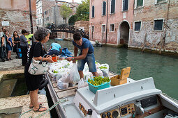 bags of vegetables, orders from Sant'Erasmo Island, delivery by boat, customers collect their plastic bags, residents, Venice, lagoon, Italy
