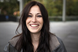 Young woman laughing at camera, Munich, Bavaria, Germany