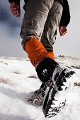 Hiker walking in snow, ascend to Unnutz Mountain (2078 m), Rofan Mountains, Tyrol, Austria