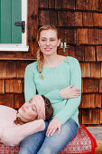 Two young women on a bench, Spitzingsee, Upper Bavaria, Germany