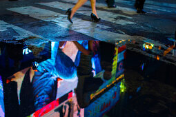 Reflection of a neon sign in a puddle, Times Square, Midtown, Manhattan, New York, USA