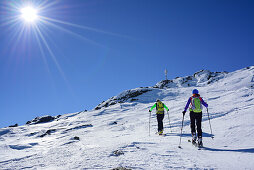 Man and woman back-country skiing ascending towards Schneespitze, Schneespitze, valley of Pflersch, Stubai Alps, South Tyrol, Italy