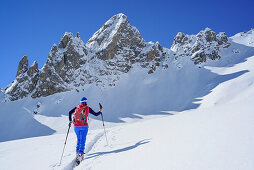 Woman back-country skiing ascending to Col Sautron, Col Sautron, Valle Maira, Cottian Alps, Piedmont, Italy