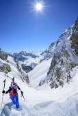 Frau auf Skitour steigt zur La Forcellina auf, Monte Viraysse im Hintergrund, Col Sautron, Valle Maira, Cottische Alpen, Piemont, Italien