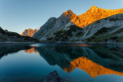 Lake Drachensee with mountain reflection, Mieminger mountains, Wetterstein mountains with Zugspitze at sunset, Coburger lodge, near Ehrwald, district Reutte, Tyrol, Austria, Europe