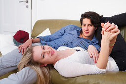 Young couple relaxing on the sofa, Embrassing