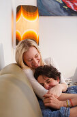 Young couple relaxing on the sofa, Embrassing