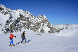 Two persons back-country skiing ascending towards Piz Lischana, Piz Lischana, Sesvenna Alps, Engadin, Grisons, Switzerland