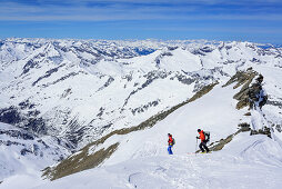 Two persons back-country skiing downhill from Dreiherrnspitze, Dreiherrnspitze, valley of Ahrntal, Hohe Tauern range, South Tyrol, Italy