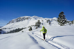 Woman back-country skiing ascending towards Munt Buffalora, Munt Buffalora, Ofenpass, Sesvenna range, Engadin, Grisons, Switzerland