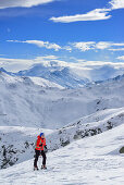 Woman back-country skiing ascending towards Schafsiedel, Schafsiedel, Kurzer Grund, Kitzbuehel range, Tyrol, Austria