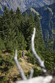A man and a woman hiking on a trail in the mountains, Oberstdorf, Bavaria, Germany
