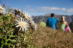 Two young hikers having a break on a sunny day, Oberstdorf, Bavaria, Germany