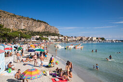 People enjoy sunny Sunday morning at Mondello beach, Mondello, near Palermo, Sicily, Italy