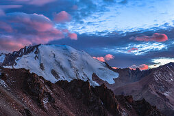 Illuminated lenticularis clouds over Tujuksu glacier, Peak Lokomotiv, Sailiski Alatau, National Park Ile Alatau, Almaty region, Kazakhstan, Central Asia, Asia