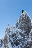 young couple rock climbing in Winter on the summit, Hochwannig, Ehrwald Tirol, Austria