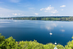 Sailing boat on Lake Starnberg in May, overlooking Tutzing, Bavaria, Germany