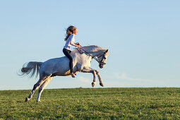 girl riding a jumping, bucking horse, Freising, Bavaria, Germany