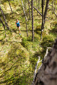 young woman running in a moorland forest, Berg at Lake Starnberg, Upper Bavaria, Germany