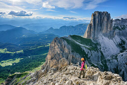 Woman descending on fixed rope route from Rotwand, Rotwand, Rosengarten, UNESCO world heritage Dolomites, Dolomites, Trentino, Italy