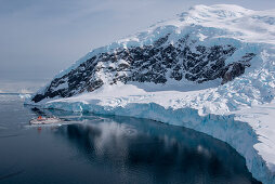 Overhead of expedition cruise ship MS Hanseatic (Hapag-Lloyd Cruises) at anchor with icy landscape, Neko Harbour, Graham Land, Antarctica