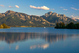 View over Forggensee to Tegelberg, Neuschwanstein castle and Saeuling, Allgaeu, Bavaria, Germany