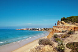 Hiker on cliffs, Praia de Falesia, Albufeira, Algarve, Portugal