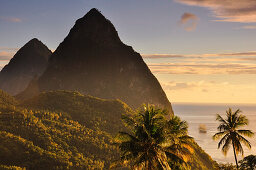 sunset with view  to sea, sailing ship and volcano mountains The Pitons with Gros and Petit Piton, Pitons Bay, UNESCO world heritage, Soufriere, St. Lucia, Saint Lucia, Lesser Antilles, Westindies, Windward Islands, Antilles, Caribbean, Central America