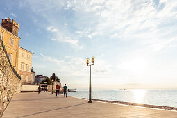 People walking along the waterfront of Porec, Istria, Croatia