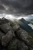 Blick vom Berg Saksa auf die Sunnmøre Alpen in dramatischem Licht kurz nach Sonnenaufgang mit dem Gipfel des Slogen über dem Norangsfjorden, Ålesund, Fylke Møre og Romsdal, Norwegen, Skandinavien