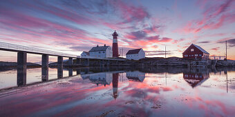 Panorama eines malerischer Sonnenuntergangs über dem Leuchtturm Tranøy Fyr im Sommer mit Spiegelung im Meer, Tranøya, Hamarøy, Nordland, Norwegen, Skandinavien