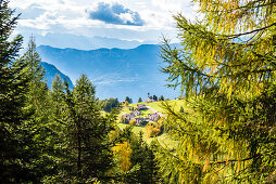 The place Radein (1550 m ü. d. M. ) situated near the Bletterbachschlucht with the Saint Wolfgang church and the mountain panorama in autumn, Radein, South Tirol, Alto Adige, Italy