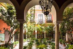 An inner courtyard of a typical old residential building in the historical centre, Seville, Andalusia, province Seville, Spain