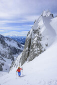 Woman back-country skiing ascending to Mandlkogelscharte, Mandlkogelscharte, Gosau range, Dachstein, Salzburg, Austria