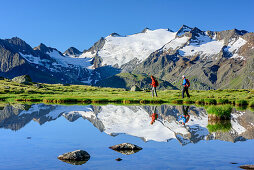 Woman and man hiking at mountain lake, Oetztal Alps in background, lake Soomsee, Obergurgl, Oetztal Alps, Tyrol, Austria