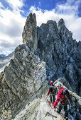 Man and woman climbing on fixed-rope route Sentiero dei Fiori, Sentiero dei Fiori, Adamello-Presanella Group, Trentino, Italy