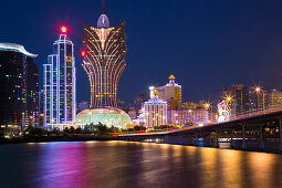 Illuminated skyline with Grand Lisboa Hotel & Casino and Ponte Governador Nobre de Carvalho Macau-Taipa Bridge at night, Macau, Macau, China