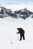 fisherman and snowy winter landscape, Melchsee-Frutt, Canton of Obwalden, Switzerland