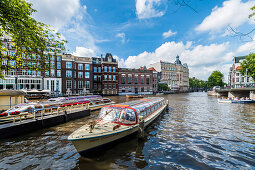 tourist boats on the Amstel in Amsterdam, Netherlands