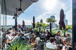 People on the terrace of the 25hours hotel and view to the Gedaechnis church, Berlin, Germany