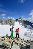 Man and woman ascending to Kuchelmooskopf, Reichenspitze and glacier Kuchelmoosferner in background, Kuchelmooskopf, Zillergrund, Reichenspitze group, Zillertal Alps, Tyrol, Austria