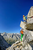 Man and woman climbing on fixed-rope route towards Richterspitze, Richterspitze, Reichenspitze group, Zillertal Alps, Tyrol, Austria