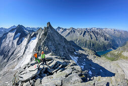 Man and woman ascending towards Richterspitze, Richterspitze, Reichenspitze group, Zillertal Alps, Tyrol, Austria